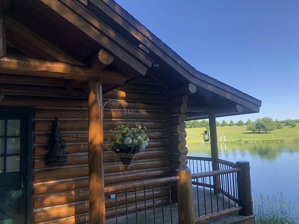 close up of log cabin on lake