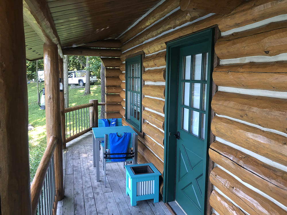 log cabin closeup with green door and window frame