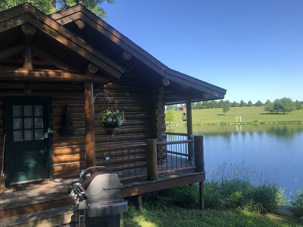 log home with bbq grill on lake