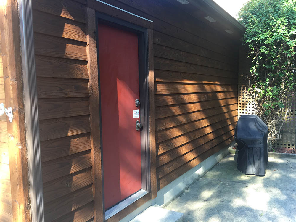 brown wooden commercial property with red door