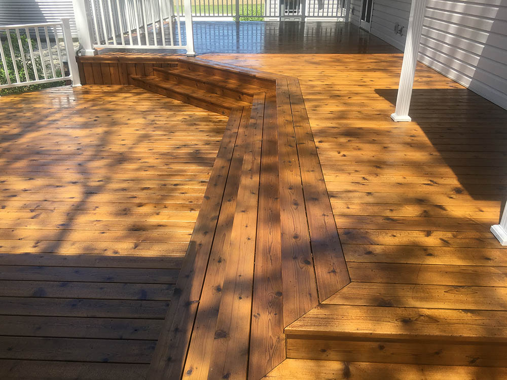 brown wooden deck in front of white home
