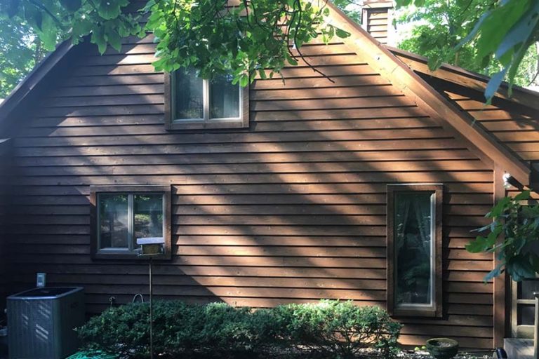 brown siding on home with trees