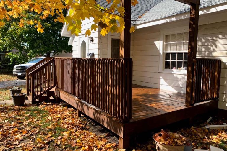 white house with clean deck and leaves