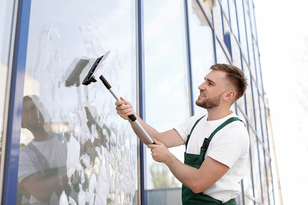 window cleaning professional cleaning commercial windows in green suspenders