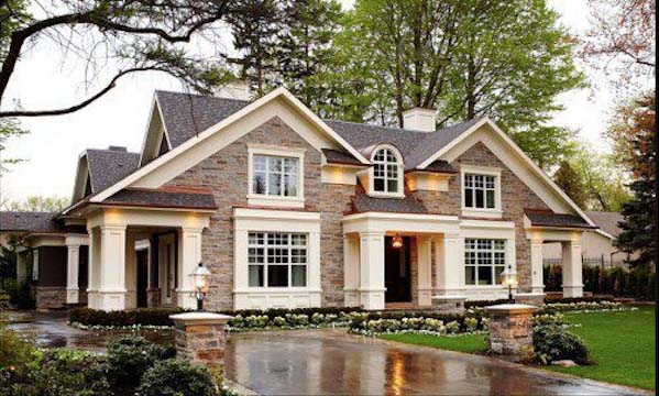 brick and white home with wet drive way